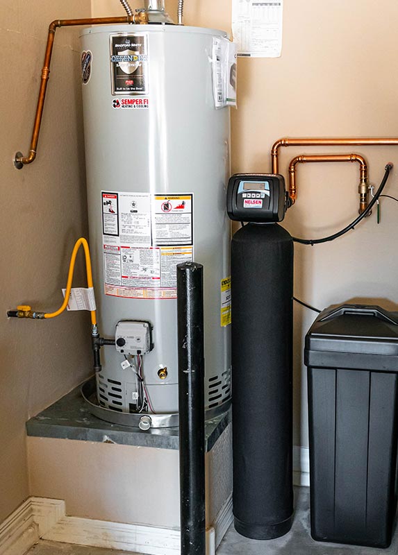 gas water heater installed in garage next to water softner